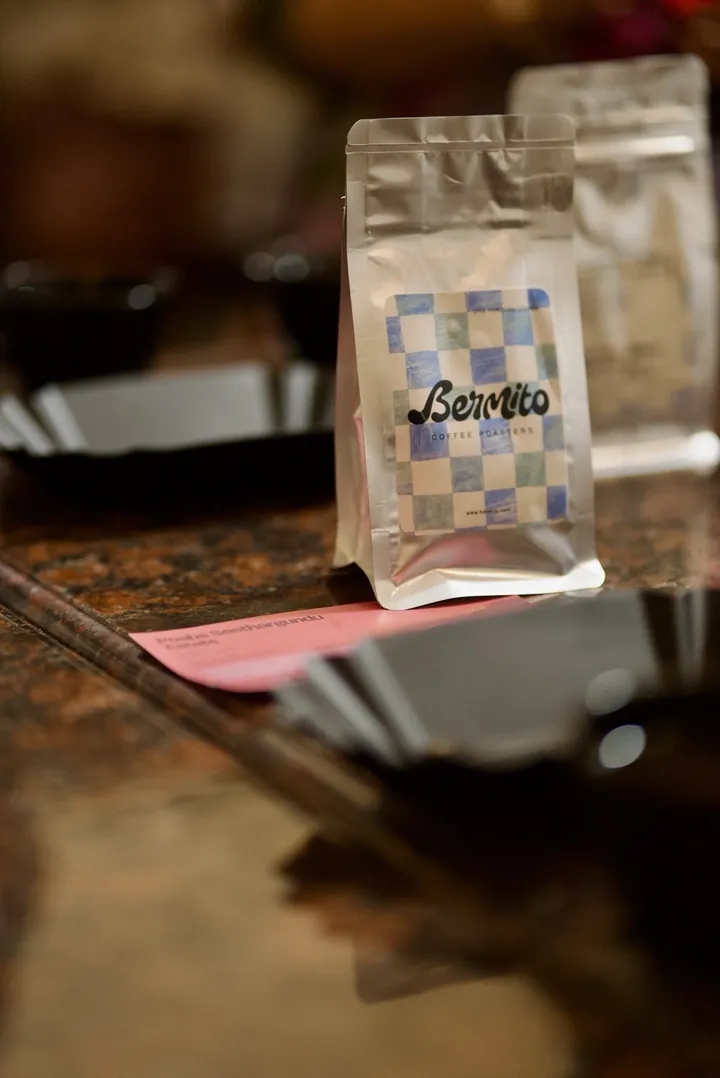 A Bermito Coffee Roasters sample bag behind cupping bowls on the Kochi tasting table.