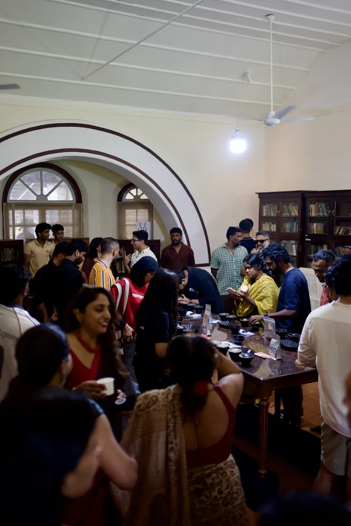 A wide view of guests sharing the long cupping table inside Cochin Club.