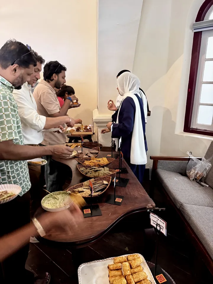 Guests serving bread and refreshments from the food table at Cochin Club.